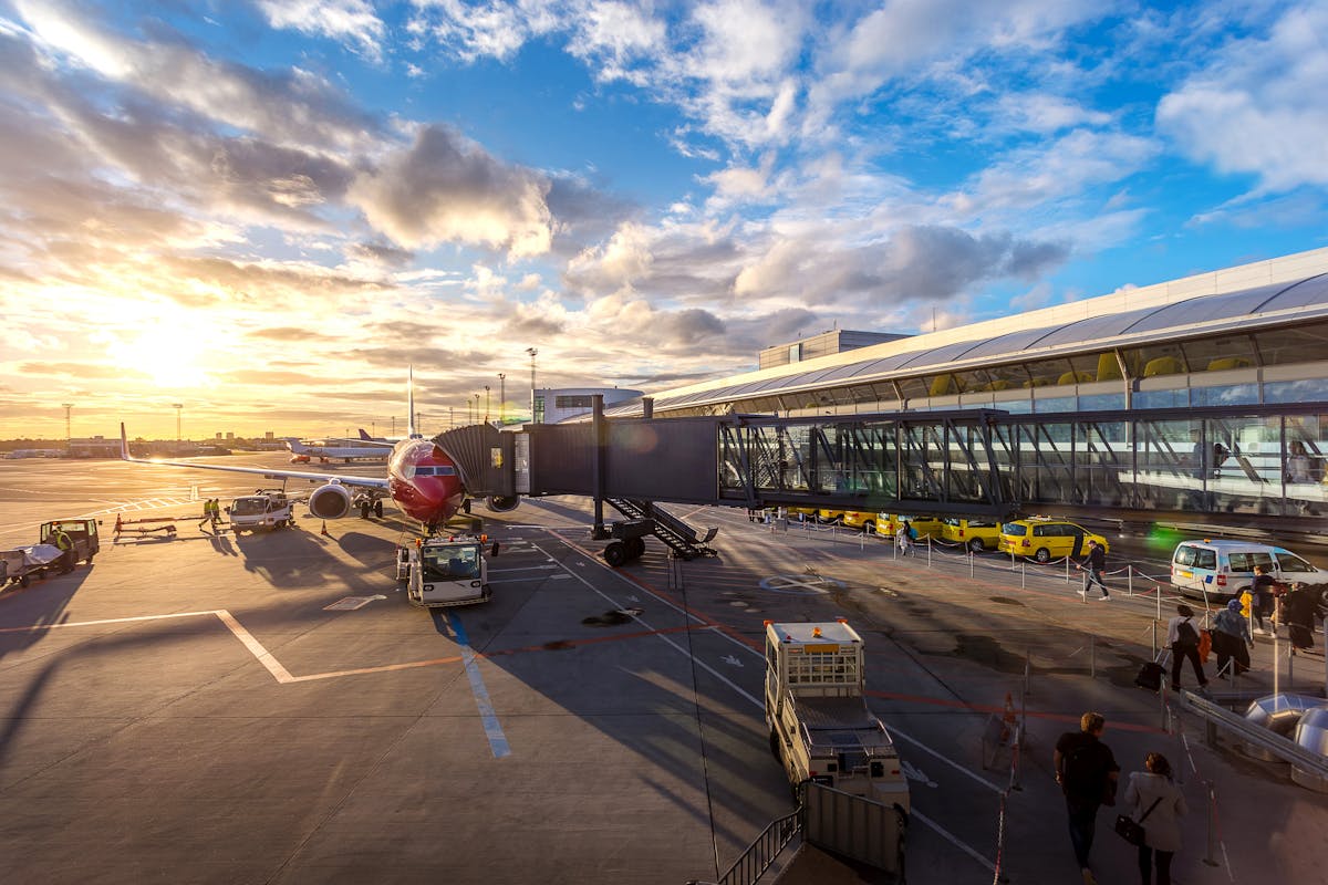 Airplane on a runway with tropical sky at golden hour
