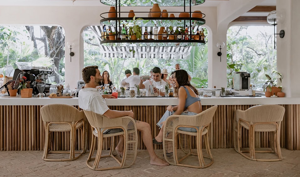 Sendero Kitchen bar area with tropical plants and rattan chairs in Nosara