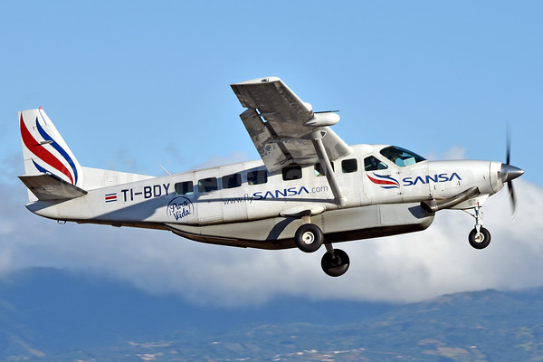 Sansa Airlines Cessna Grand Caravan in flight over Costa Rica with mountains in the background