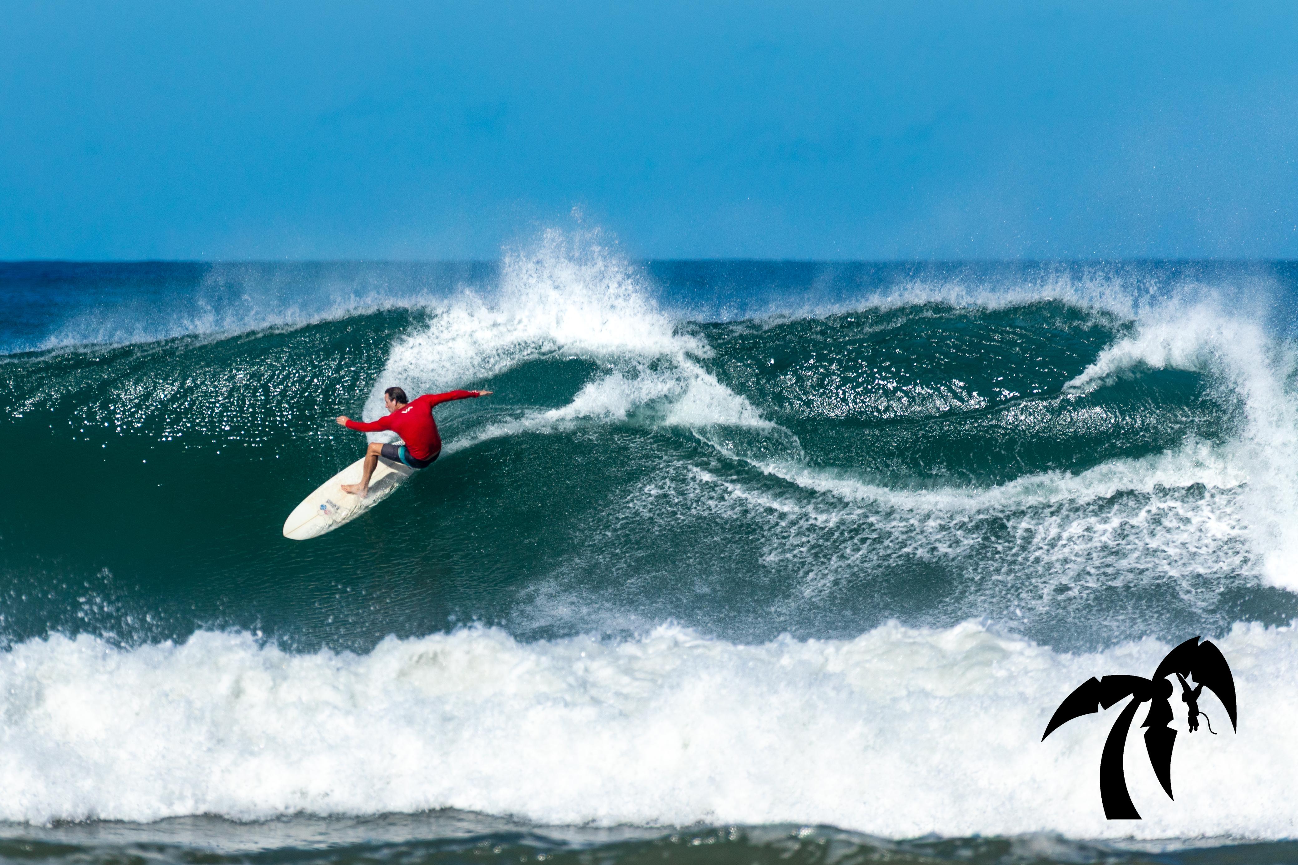 Experienced surfer carving a powerful wave at Playa Guiones, Nosara
