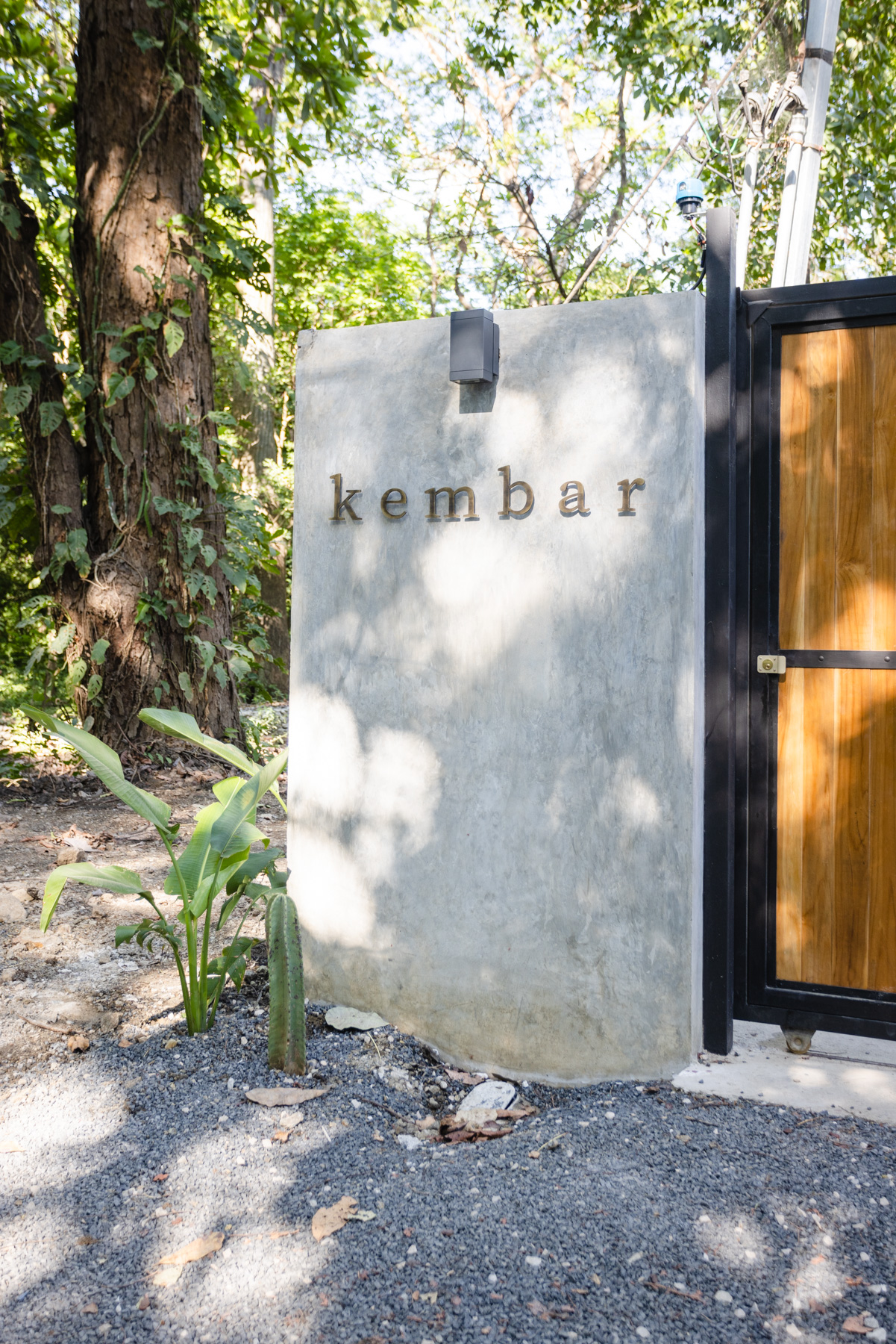 Kembar Nosara entrance with brass lettering on concrete wall