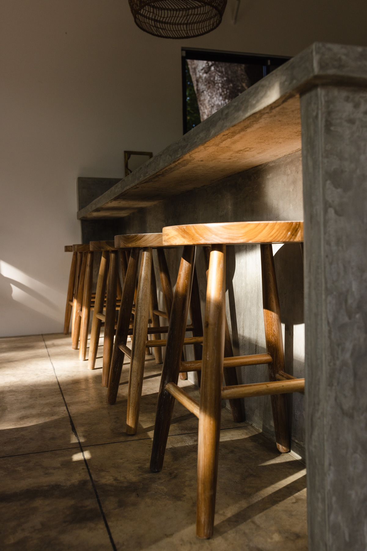 Handcrafted wood bar stools at concrete counter