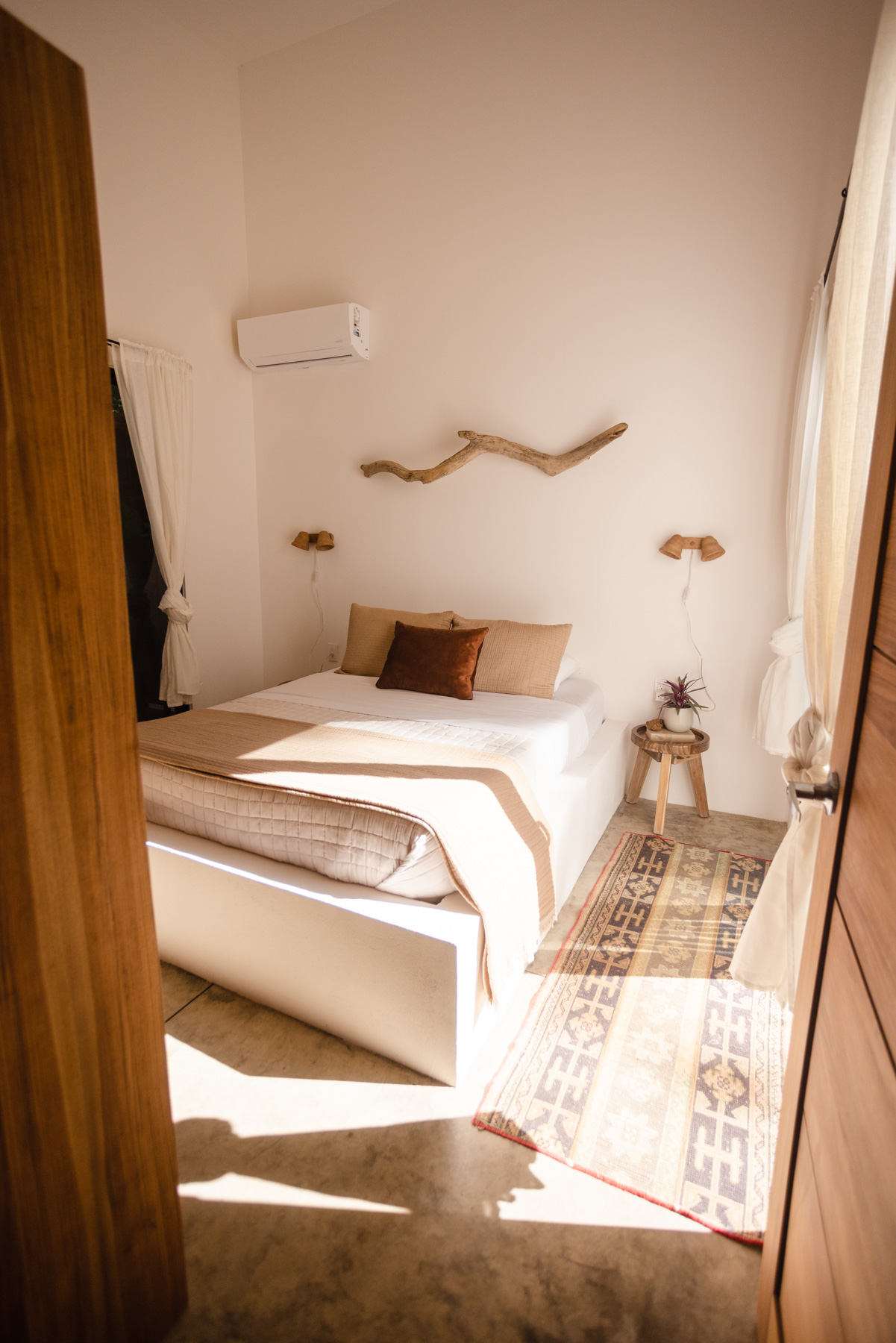 Bedroom with warm earth tones and driftwood art