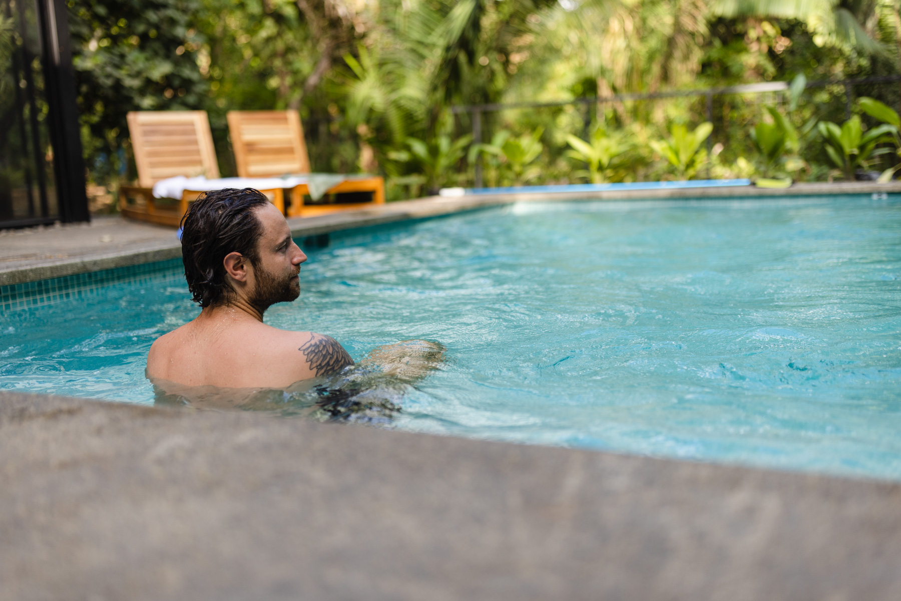 Swimming in the pool with jungle backdrop