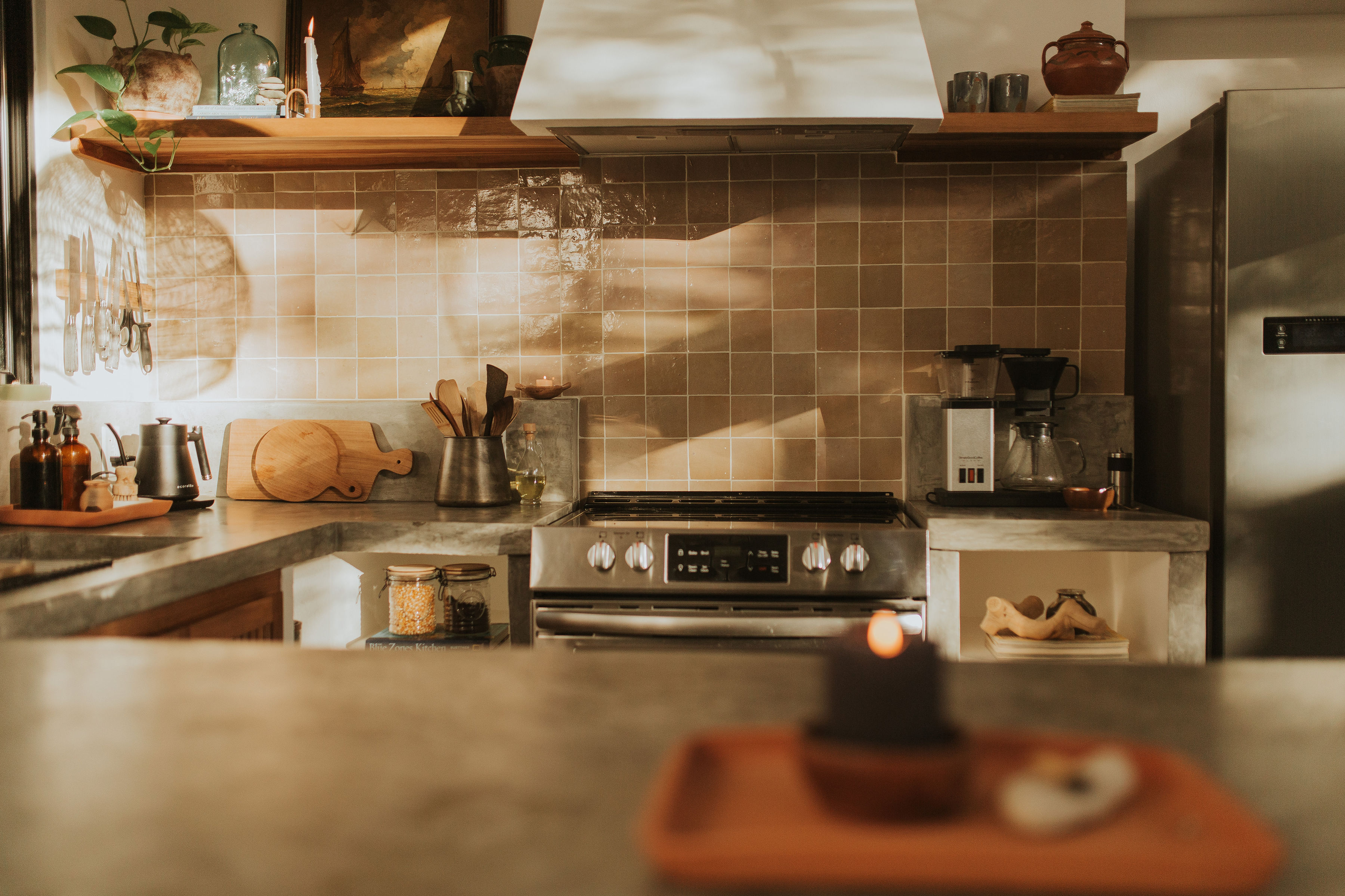 Chef's kitchen with concrete countertops and artisan tile
